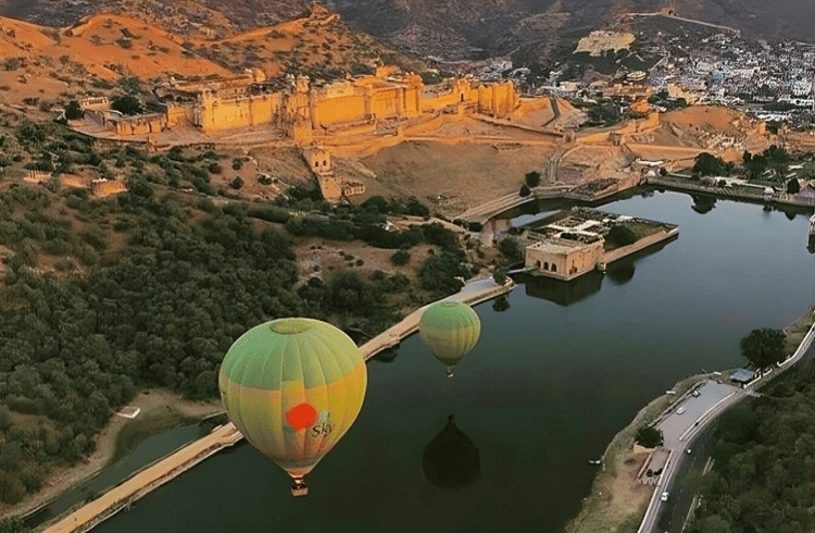 Hot air balloon flying over Jaipur city at sunrise
